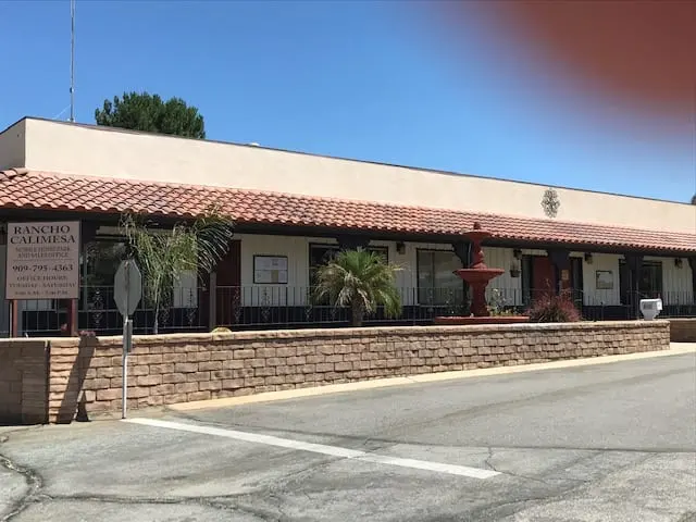 The clubhouse and office entrance with the Rancho Calimesa sign and fountain