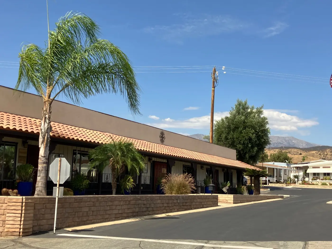 The Rancho Calimesa clubhouse with palms and the mountains behind it